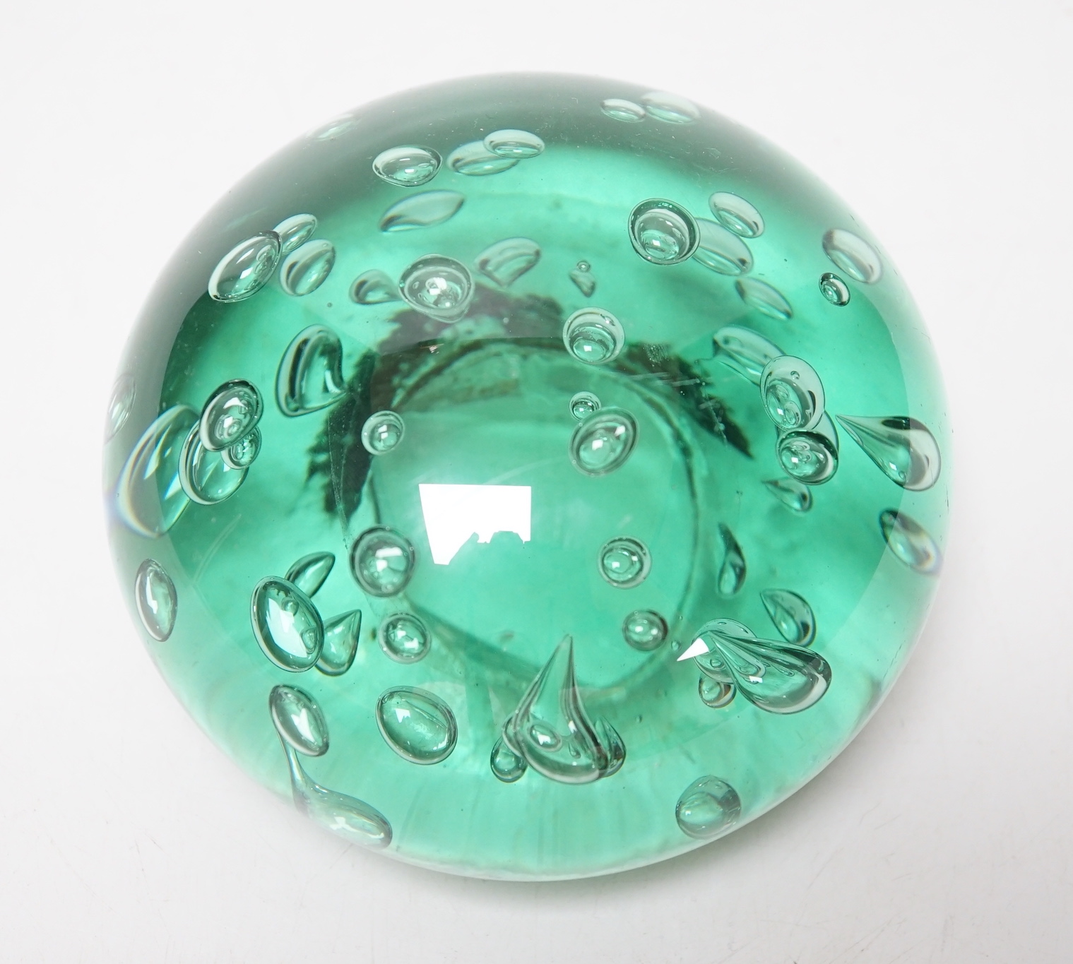 A large Victorian green glass domed dump or paperweight, 14 cm diameter